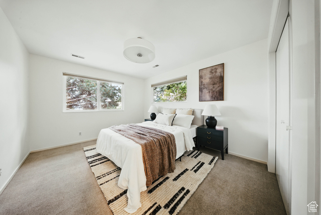 Carpeted bedroom featuring baseboards