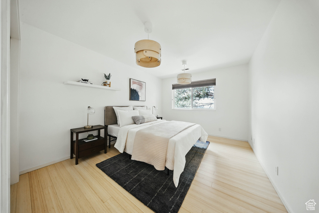 Bedroom featuring wood finished floors and baseboards