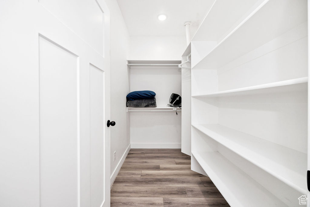 Walk in closet featuring wood finished floors