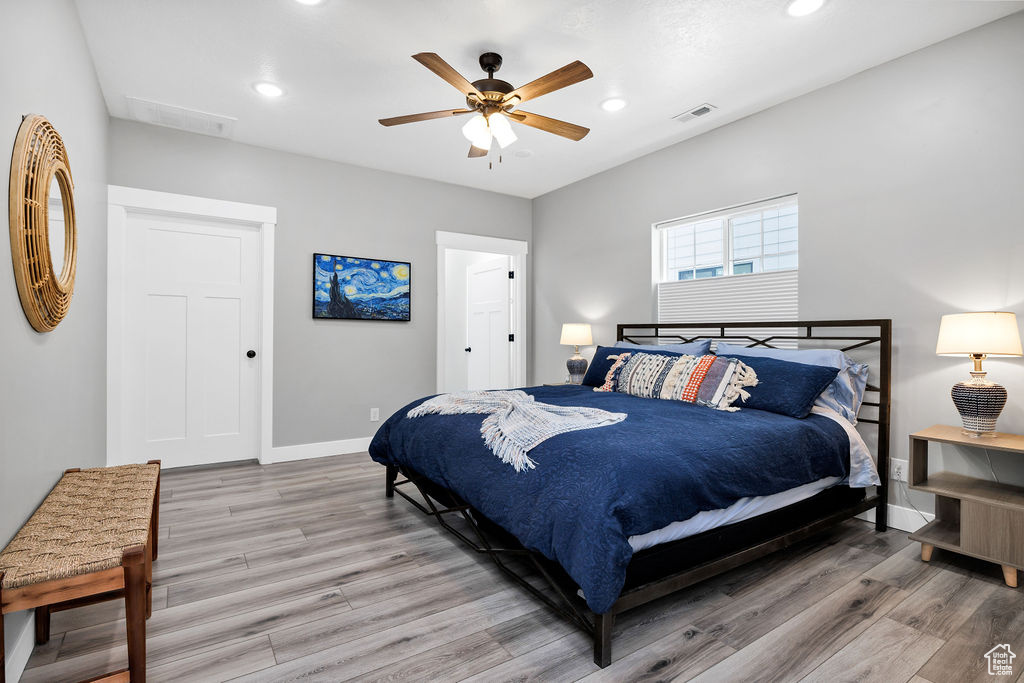 Bedroom with baseboards, light wood finished floors, recessed lighting, and a ceiling fan