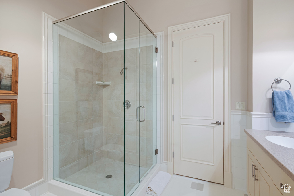 Bathroom with a stall shower, toilet, and vanity