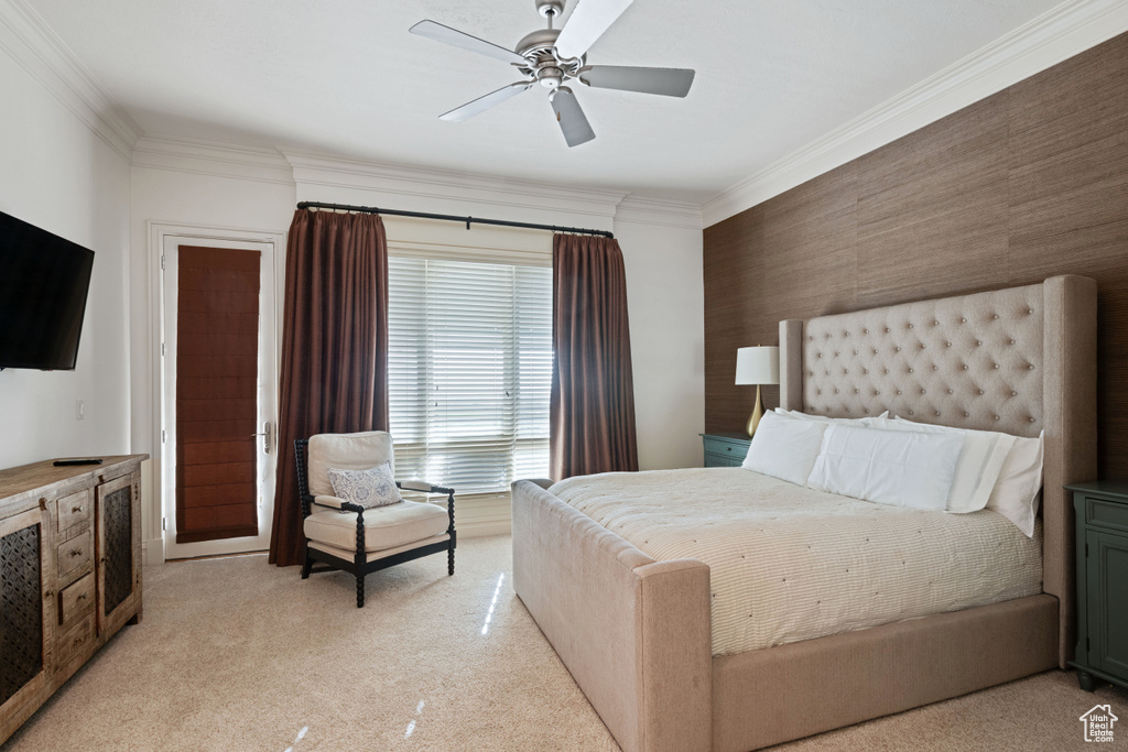 Bedroom featuring crown molding, light carpet, and a ceiling fan