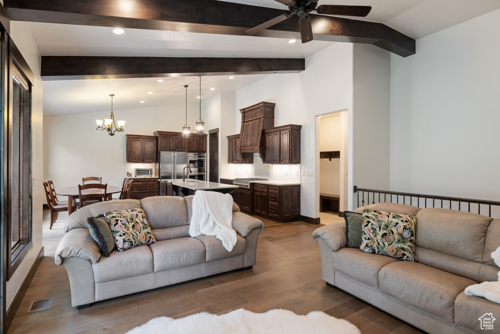 Living area featuring ceiling fan, a chandelier, wood finished floors, and recessed lighting