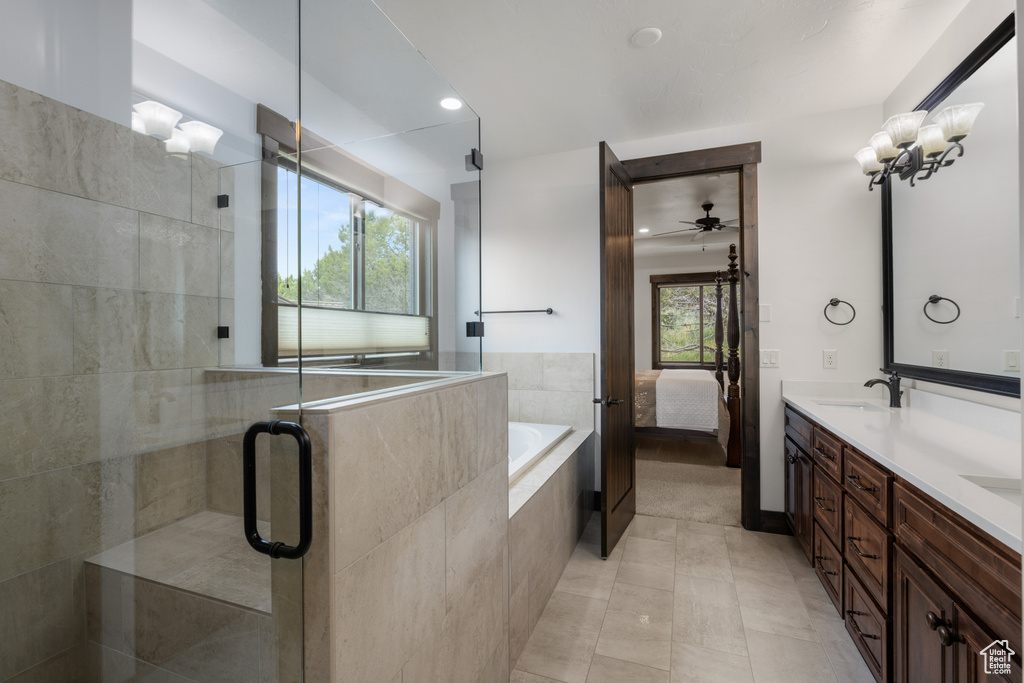 Full bath featuring a shower stall, double vanity, ceiling fan, tile patterned floors, and ensuite bathroom