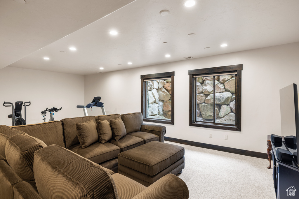 Living room featuring carpet, recessed lighting, and baseboards