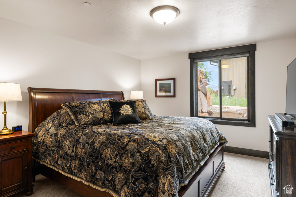 Carpeted bedroom featuring baseboards