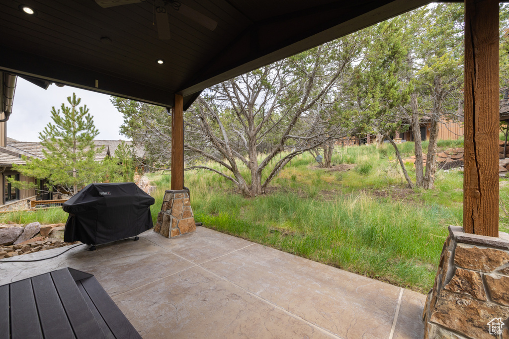 View of patio with a ceiling fan and a grill