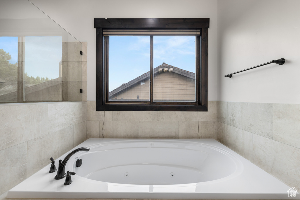 Bathroom with a whirlpool tub and healthy amount of natural light