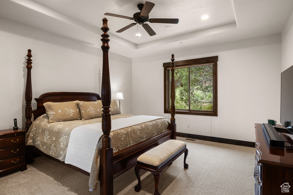 Bedroom with carpet flooring, a raised ceiling, baseboards, and recessed lighting
