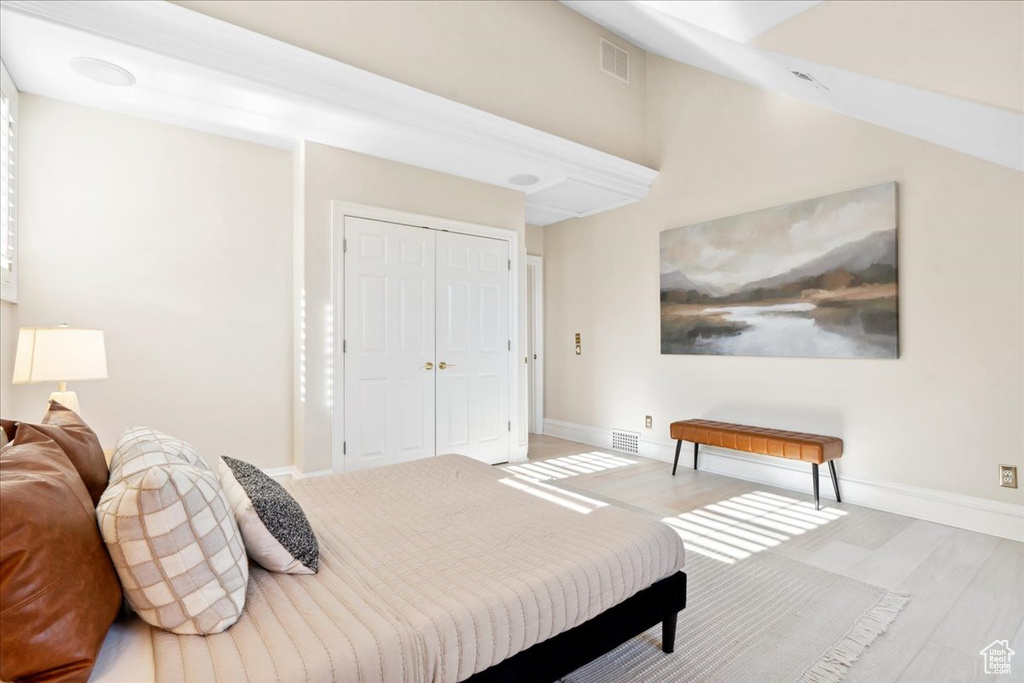 Bedroom featuring wood finished floors, baseboards, and a closet
