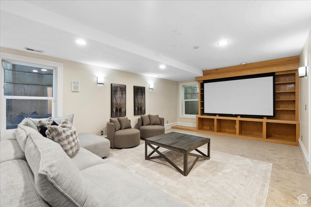 Cinema room with recessed lighting and light carpet