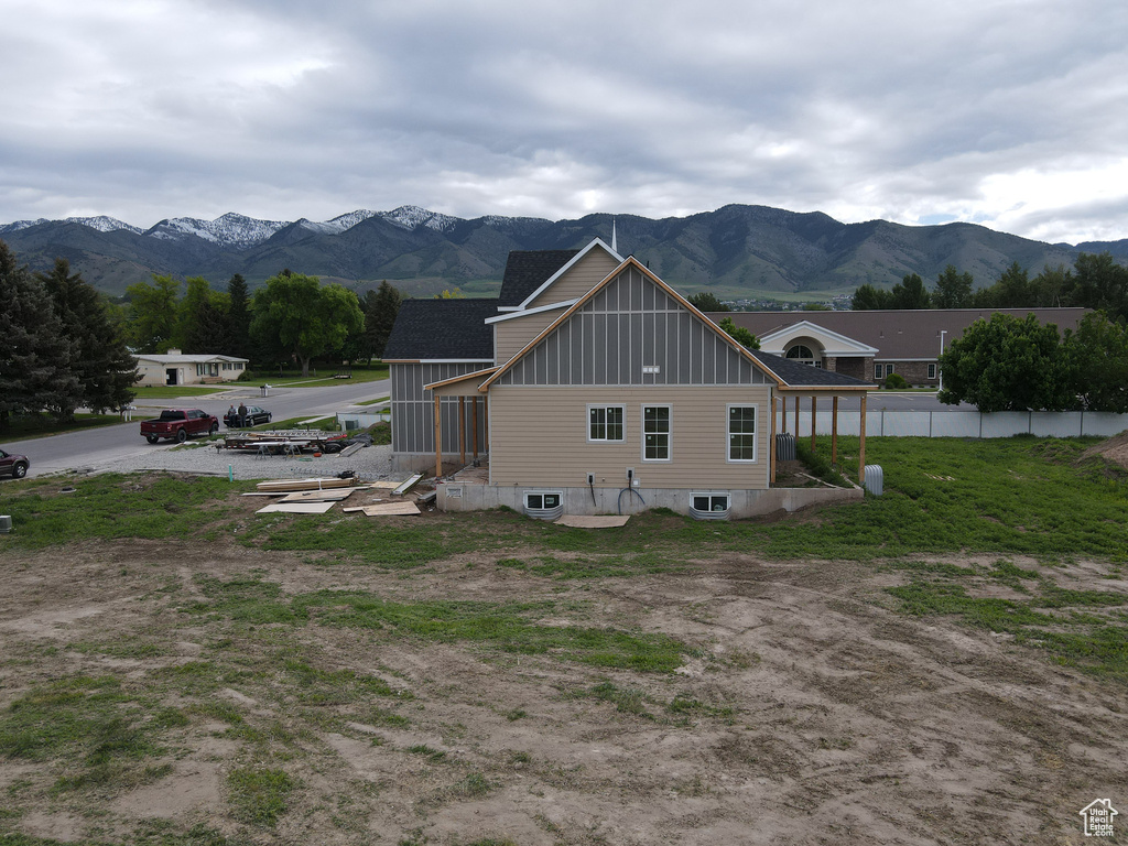 View of property exterior with board and batten siding and a mountain view