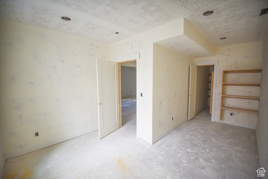 Unfurnished bedroom with baseboards and a textured ceiling