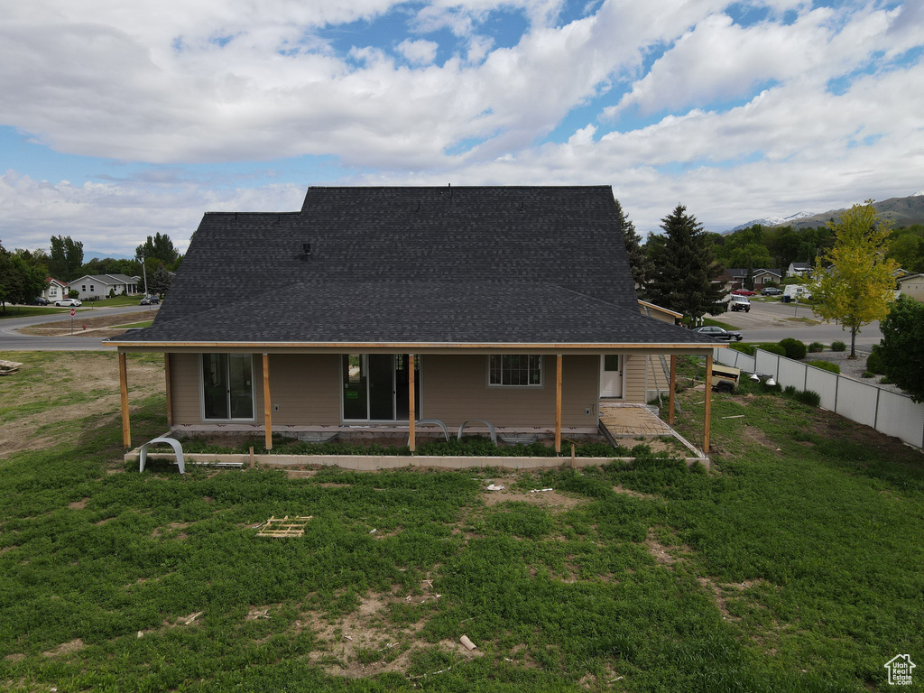 Back of house with a shingled roof
