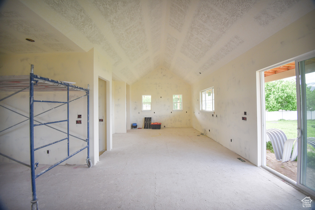 Empty room featuring lofted ceiling