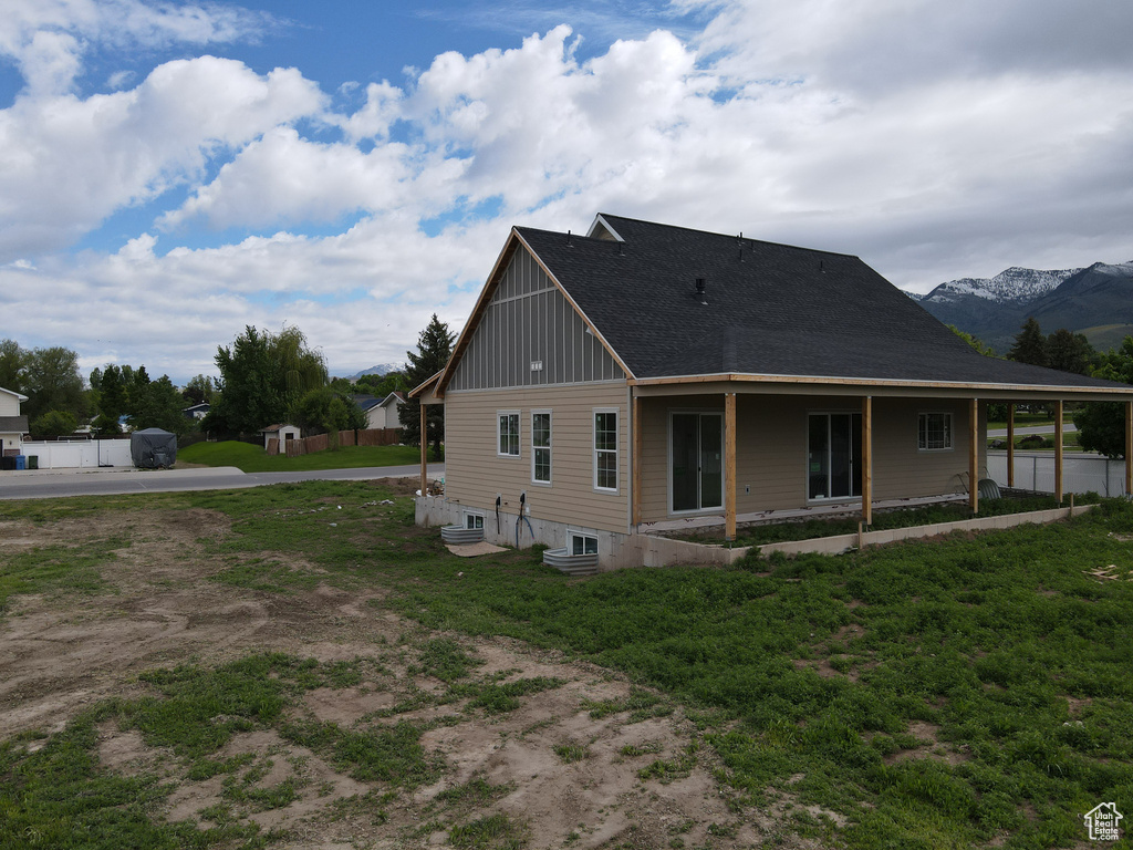 Rear view of property featuring board and batten siding and a mountain view