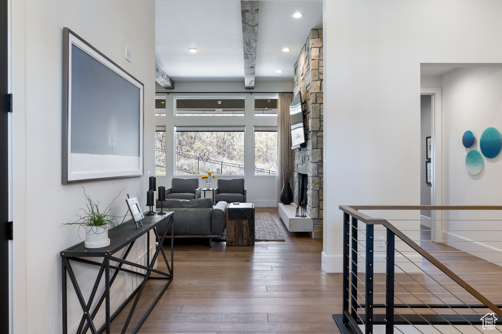 Corridor with hardwood / wood-style floors, baseboards, recessed lighting, and an upstairs landing