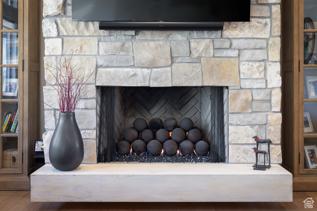 Detailed view of a fireplace and wood finished floors