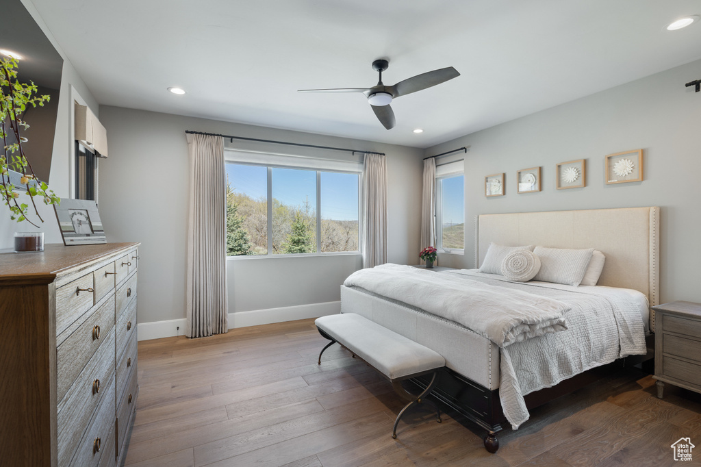 Bedroom featuring baseboards, recessed lighting, dark wood-type flooring, and a ceiling fan
