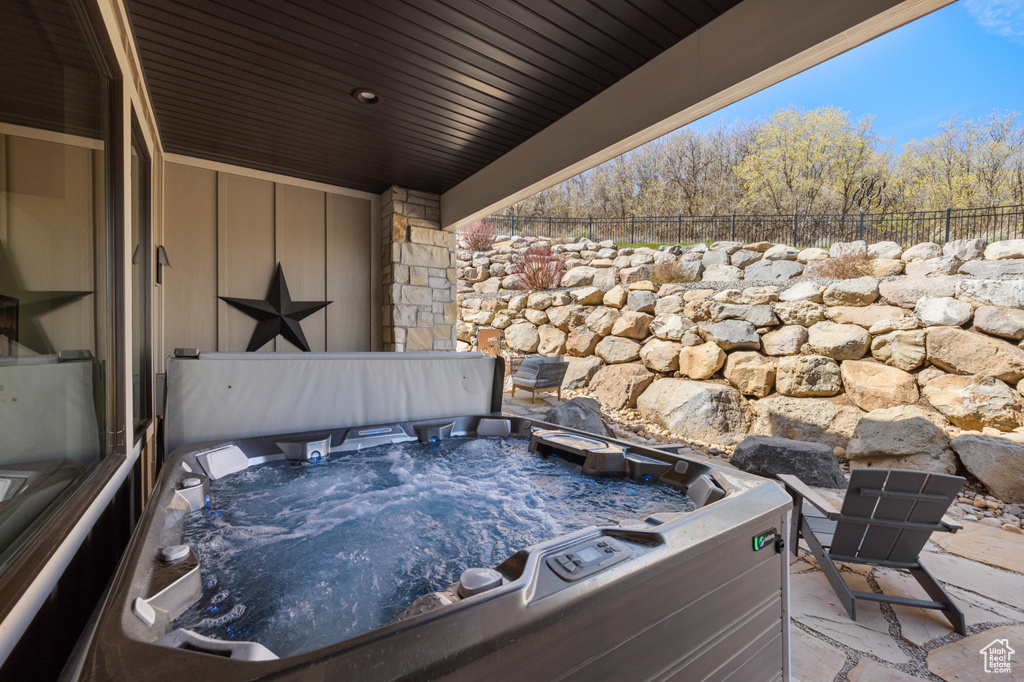 View of patio with a hot tub