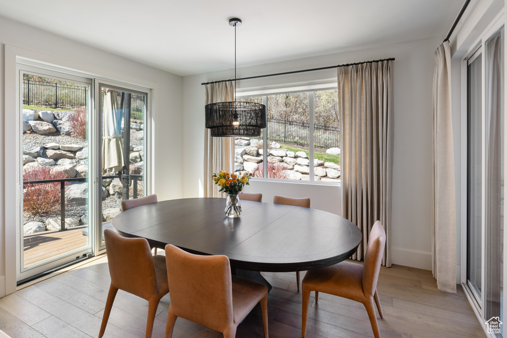 Dining space with light wood finished floors and baseboards