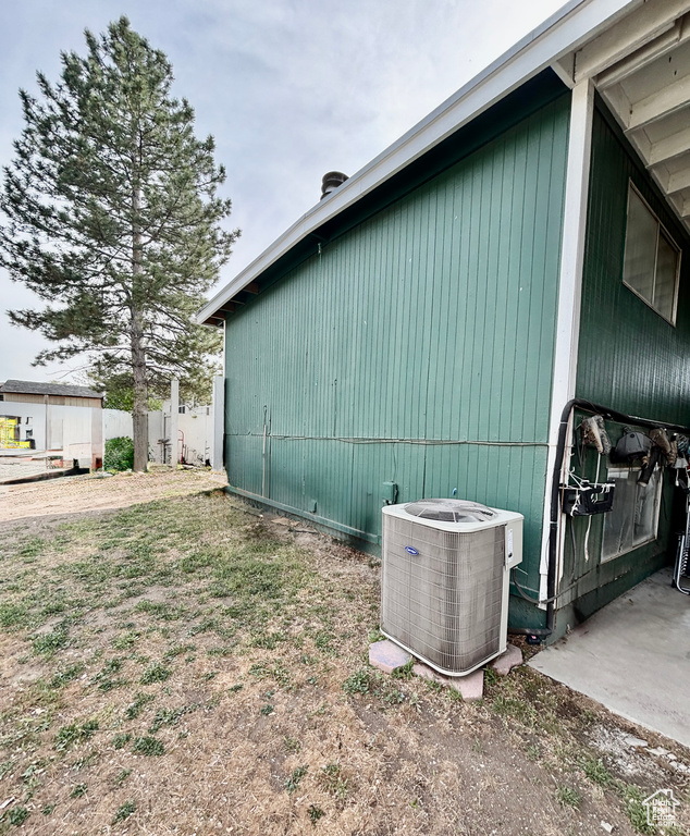 View of side of property with central AC unit