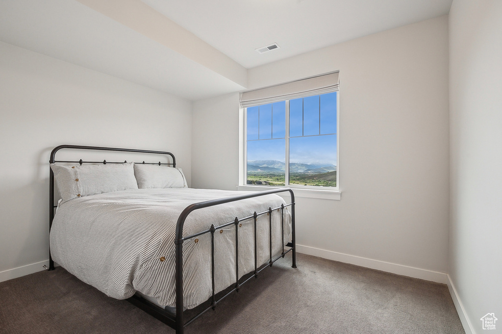 Carpeted bedroom with baseboards