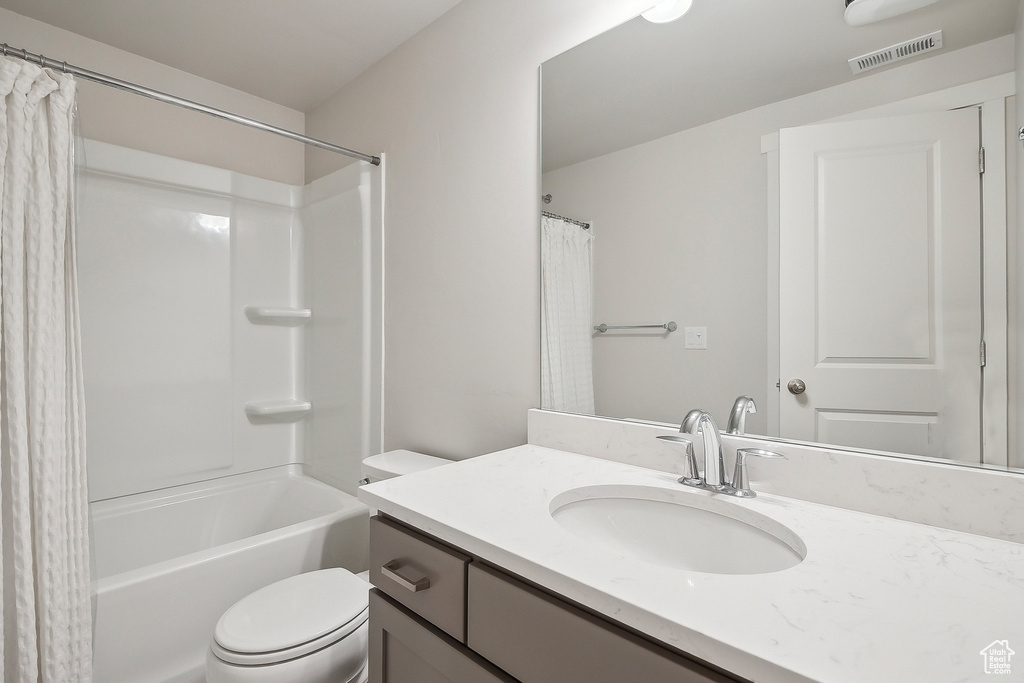 Full bathroom with toilet and vanity