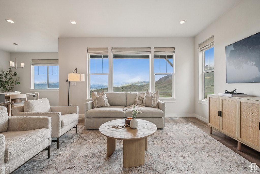 Living area with wood finished floors, recessed lighting, and baseboards