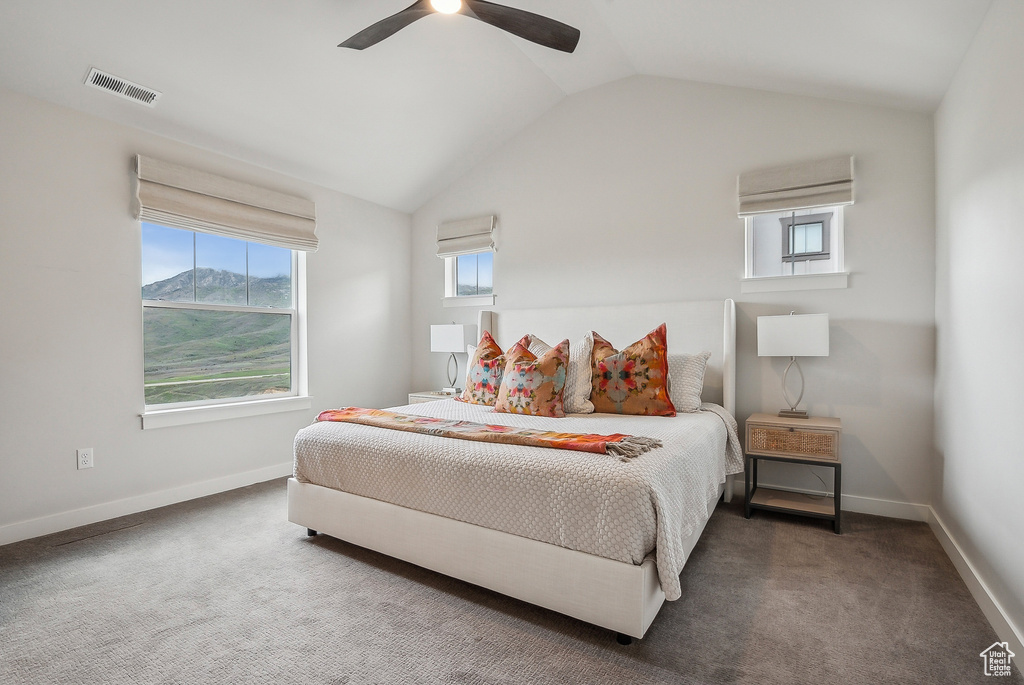 Bedroom with vaulted ceiling, carpet, baseboards, and ceiling fan