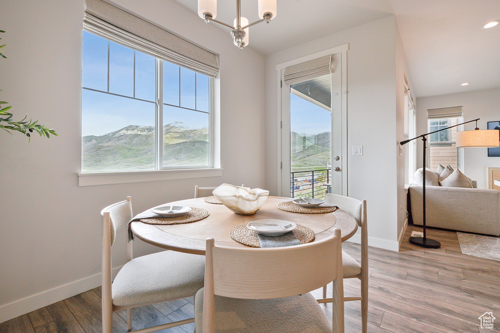 Dining space with light wood-style flooring, baseboards, and recessed lighting