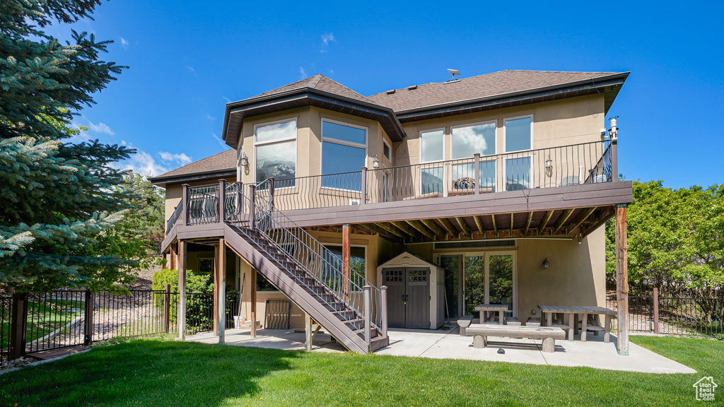 Back of house with a patio area, roof with shingles, a deck, and stairs