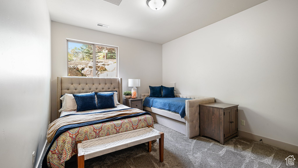 Carpeted bedroom featuring baseboards