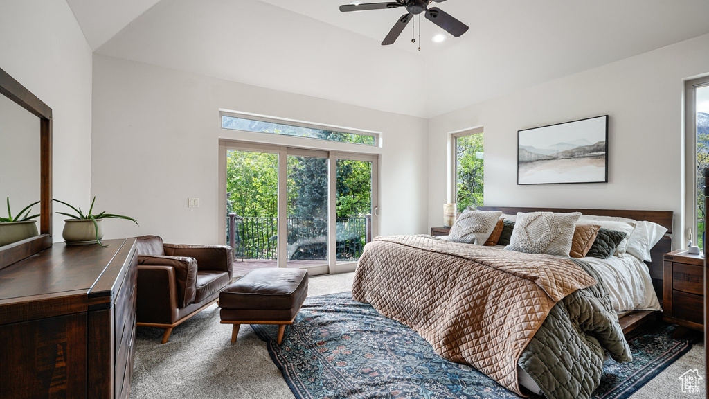 Carpeted bedroom featuring access to outside, multiple windows, and ceiling fan