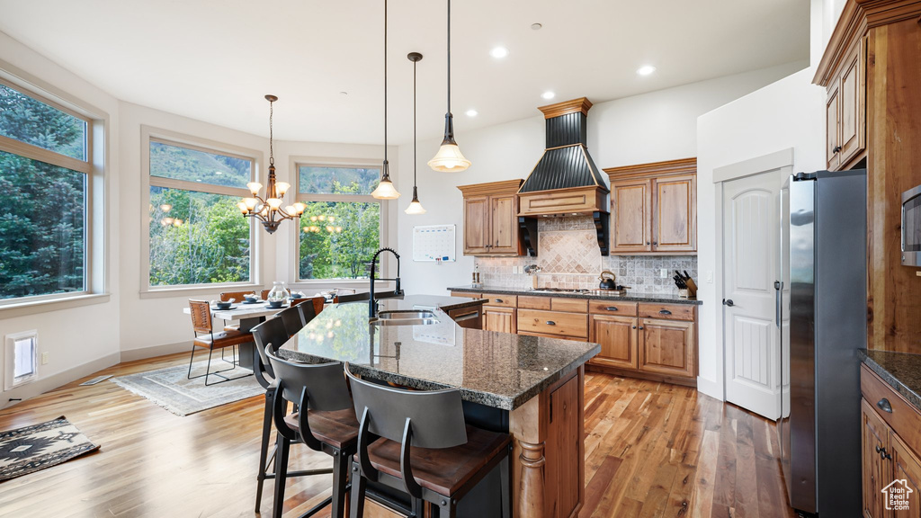Kitchen featuring a sink, stainless steel appliances, light wood-type flooring, healthy amount of natural light, and recessed lighting