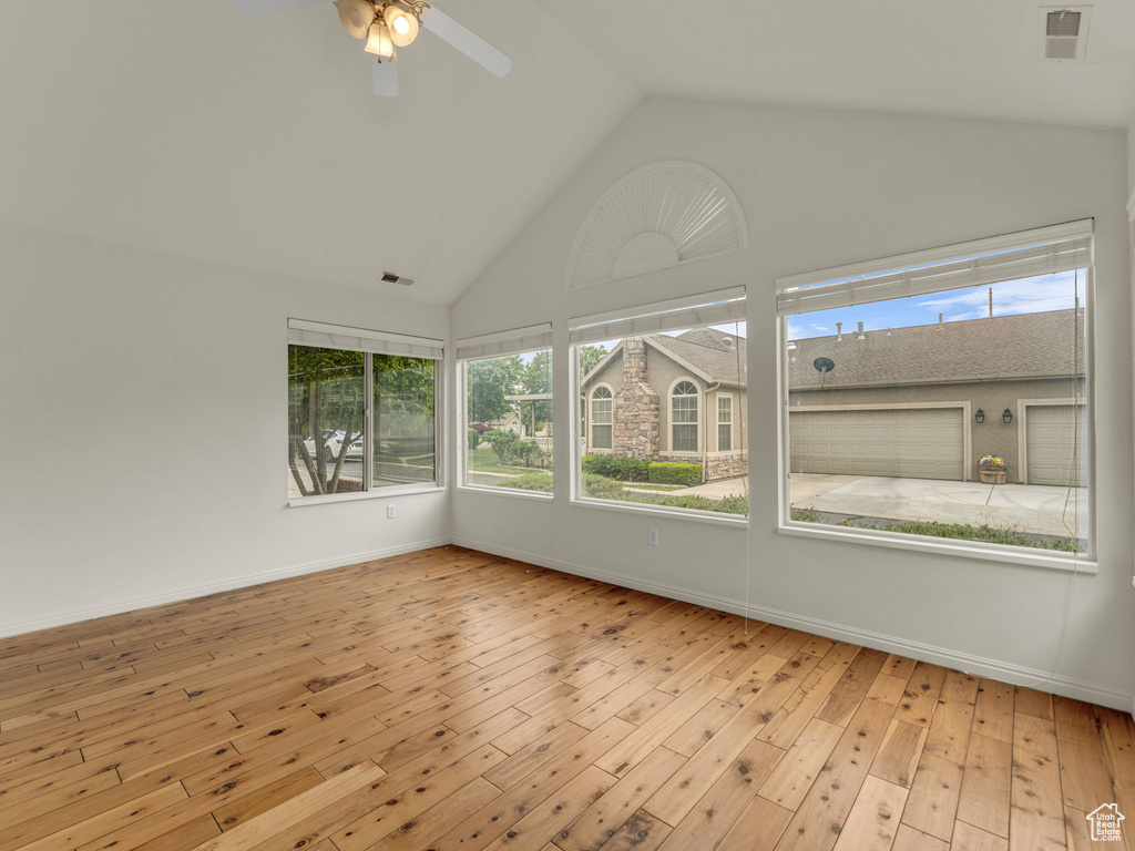 Unfurnished sunroom with lofted ceiling