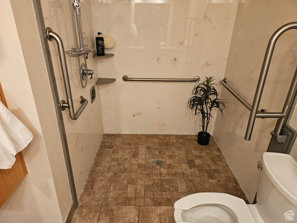 Full bath featuring toilet and a shower