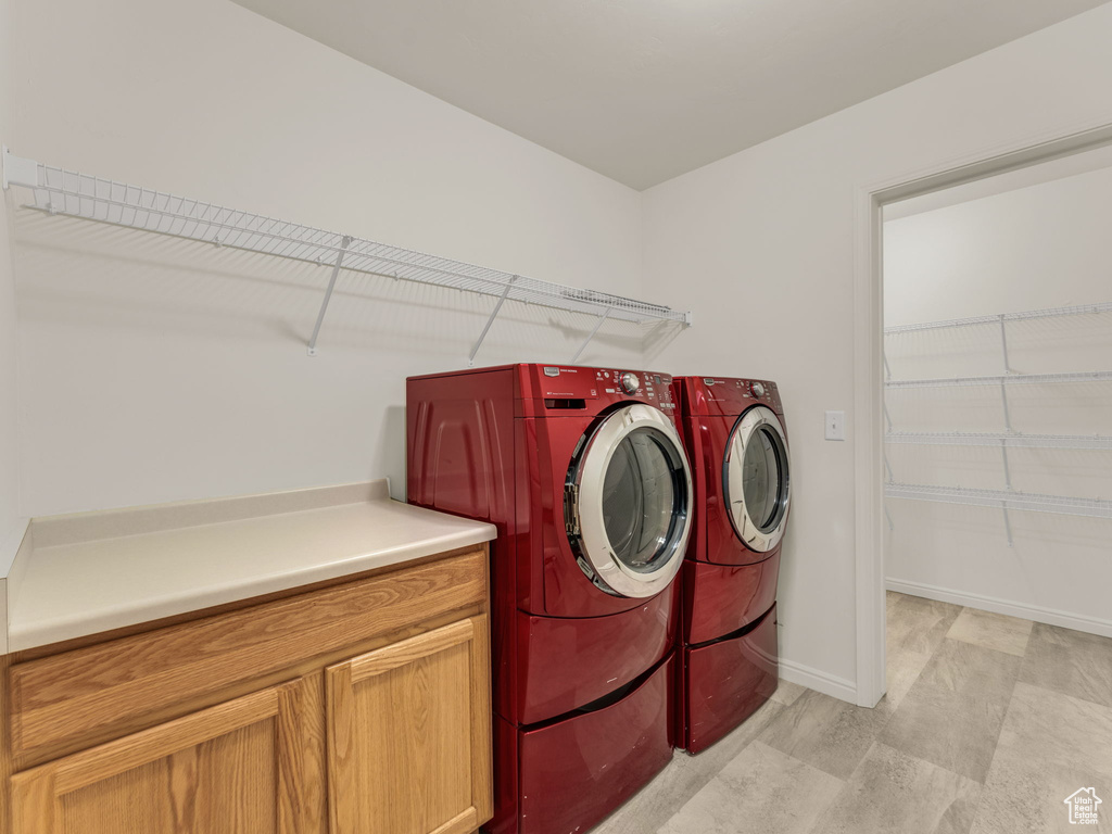 Laundry room featuring independent washer and dryer and baseboards