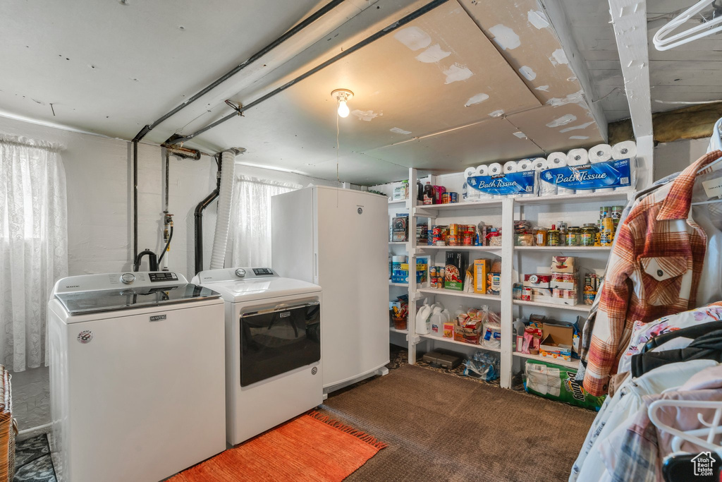 Laundry room featuring washer and dryer and carpet floors