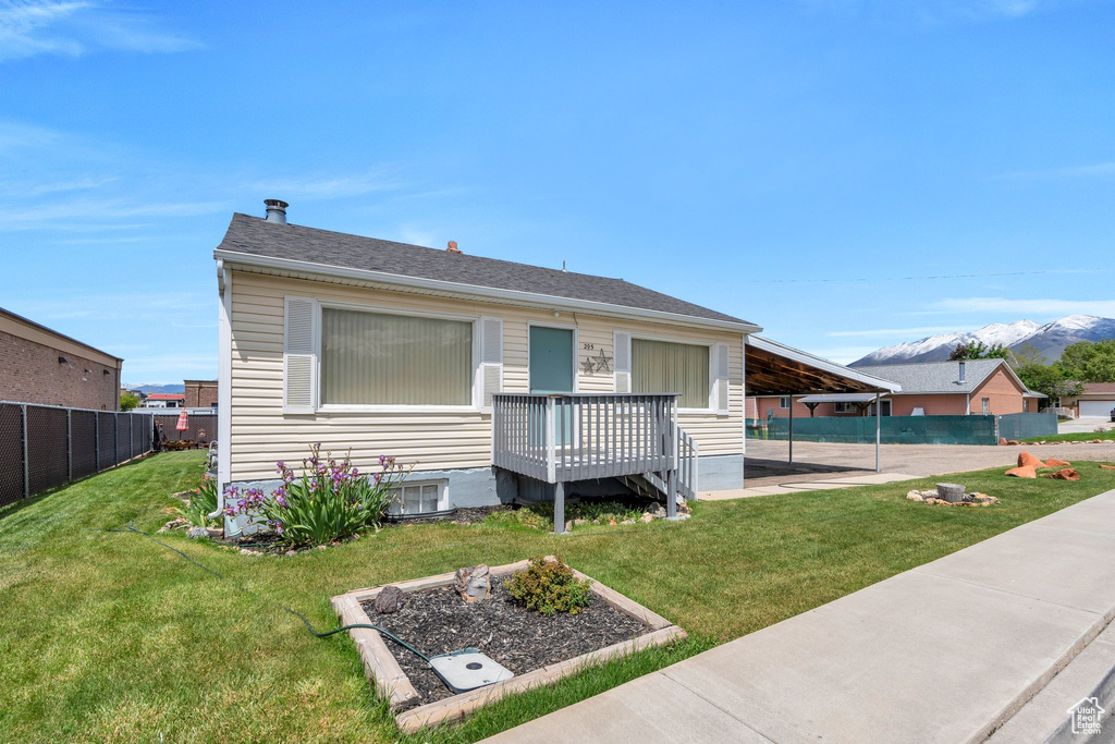 View of front of property with a mountain view, cooling unit, and roof with shingles