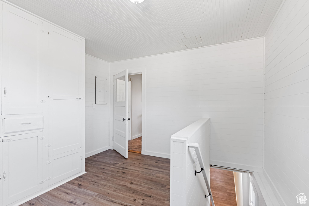 Hallway featuring wood finished floors and an upstairs landing