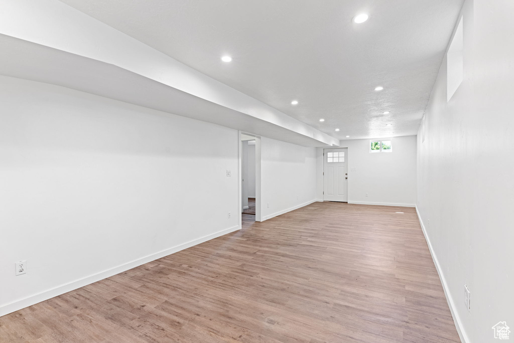 Basement featuring recessed lighting, light wood finished floors, and baseboards