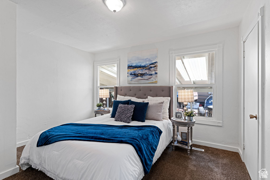 Carpeted bedroom with baseboards