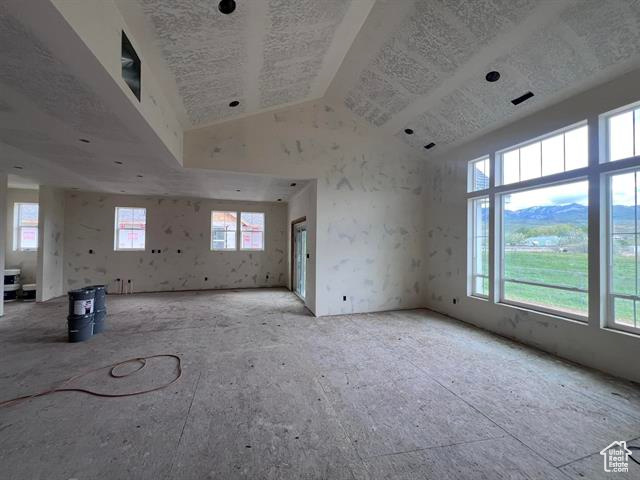 Empty room with plenty of natural light and high vaulted ceiling