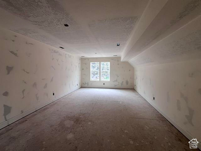 Bonus room featuring a textured ceiling