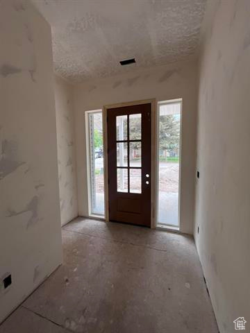 Foyer with healthy amount of natural light and a textured ceiling