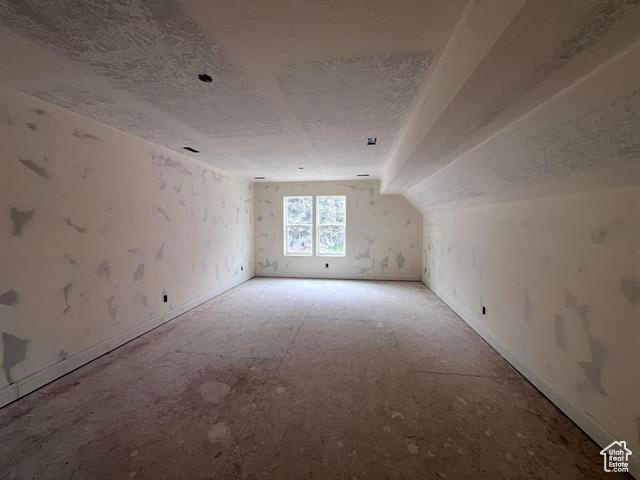 Additional living space featuring a textured ceiling