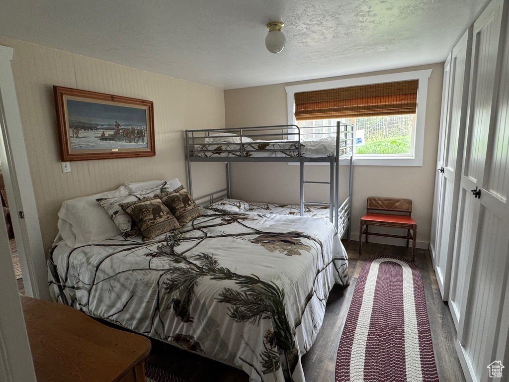Bedroom featuring wood finished floors and baseboards
