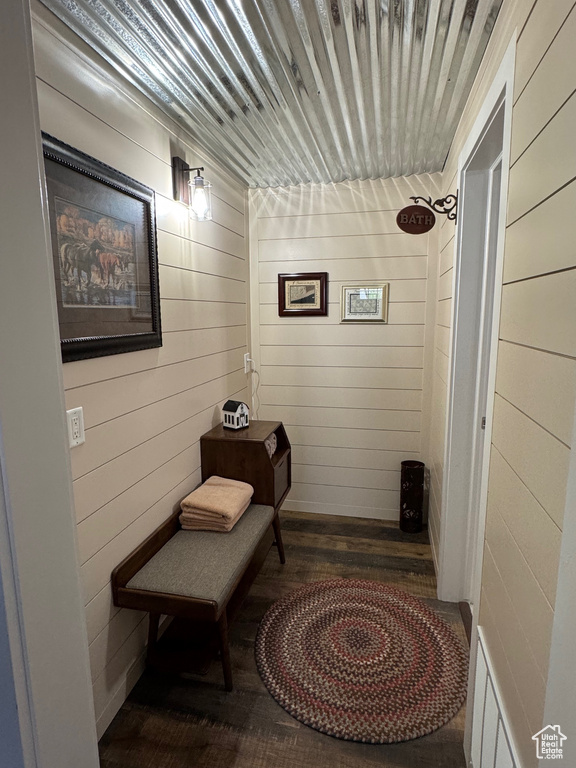 Hallway featuring wood finished floors and wood walls