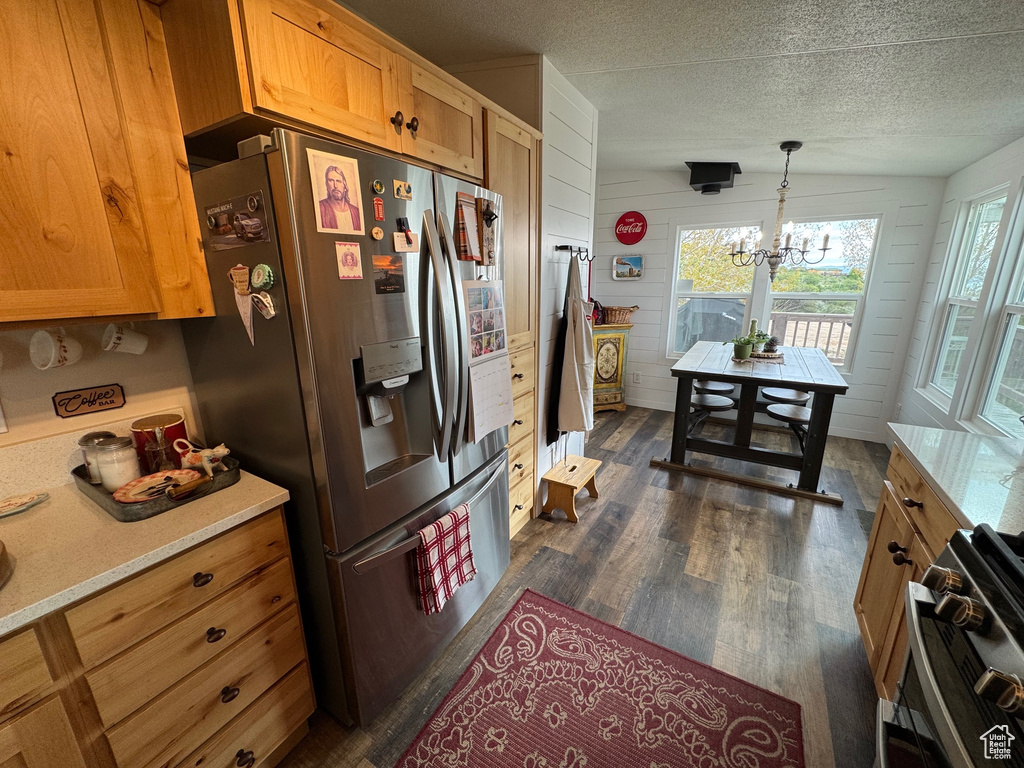 Kitchen with appliances with stainless steel finishes, a chandelier, plenty of natural light, light countertops, and a textured ceiling